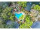 Aerial view showcasing the heart-shaped community pool, surrounding trees, and outdoor lounge area at 940 Douglas Ave # 132, Altamonte Springs, FL 32714