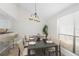 Bright dining room with large window, adjacent to a kitchen bar area at 940 Douglas Ave # 132, Altamonte Springs, FL 32714