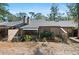 Back exterior featuring a yard with a screened in back porch and lush landscaping at 940 Douglas Ave # 132, Altamonte Springs, FL 32714