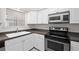 A kitchen featuring stainless steel appliances, white cabinets, and neutral countertops at 940 Douglas Ave # 132, Altamonte Springs, FL 32714