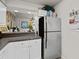 Kitchen area with stainless steel refrigerator and view into the dining area at 940 Douglas Ave # 132, Altamonte Springs, FL 32714