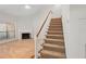 Cozy living room featuring a fireplace and staircase, creating an inviting atmosphere at 940 Douglas Ave # 132, Altamonte Springs, FL 32714