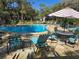Community pool with chairs and shade offers a relaxing outdoor amenity at 940 Douglas Ave # 132, Altamonte Springs, FL 32714