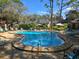 Community pool surrounded by lounge chairs and umbrellas, offering a refreshing oasis at 940 Douglas Ave # 132, Altamonte Springs, FL 32714