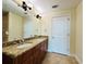 Bathroom featuring a double-sink vanity with granite countertops and two doors at 101 S Eola Dr # 1009, Orlando, FL 32801