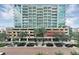 Attractive exterior view of a multi-story condo building with meticulous landscaping and visible parking at 101 S Eola Dr # 1009, Orlando, FL 32801