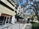 Street view of a commercial building showcasing accessible entrances and outdoor dining at 101 S Eola Dr # 1009, Orlando, FL 32801