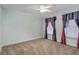 Bedroom with a ceiling fan, neutral carpet and unique, colorful window treatments at 10384 Se 41St Ter, Belleview, FL 34420