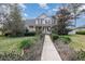 Inviting two-story home featuring a charming front porch and a beautifully landscaped front yard at 10384 Se 41St Ter, Belleview, FL 34420