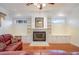 Spacious living room featuring a fireplace, built-in shelving, and hardwood flooring at 10384 Se 41St Ter, Belleview, FL 34420