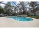 Sparkling pool surrounded by a screened enclosure and beautiful greenery at 10384 Se 41St Ter, Belleview, FL 34420