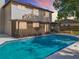 Backyard showcasing in-ground pool and screened lanai of white, two-story home set against a colorful sky at 1040 Waverly Dr, Longwood, FL 32750