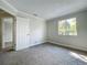 Bedroom featuring neutral walls and carpet, a window, and a door leading to the bathroom at 1040 Waverly Dr, Longwood, FL 32750