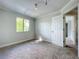 Bright bedroom with a neutral color palette, gray carpet, a window, and a track lighting fixture at 1040 Waverly Dr, Longwood, FL 32750