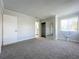 Light and open bedroom with carpet, a closet, and a window with curtains next to a bathroom at 1040 Waverly Dr, Longwood, FL 32750