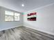 Bedroom with gray wood-look flooring, natural light, and neutral paint at 1040 Waverly Dr, Longwood, FL 32750