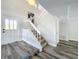 Bright foyer with hardwood floors, white staircase, and natural light creates a welcoming entryway at 1040 Waverly Dr, Longwood, FL 32750