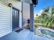 Close up of a well-maintained front porch with a water feature and manicured landscaping at 1040 Waverly Dr, Longwood, FL 32750