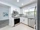 Bright kitchen boasts white cabinets, stainless steel appliances, and quartz countertops at 1040 Waverly Dr, Longwood, FL 32750