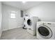 Laundry room with white washer and dryer and gray tile floors at 1040 Waverly Dr, Longwood, FL 32750