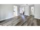 Spacious living room showcasing wood flooring and connecting to the kitchen and stairway at 1040 Waverly Dr, Longwood, FL 32750