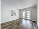 Living room with wood floors, neutral walls, and a sliding glass door to screened-in porch at 1040 Waverly Dr, Longwood, FL 32750