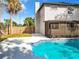 A refreshing in-ground pool with a screened-in lanai, next to the home's white exterior and well-kept backyard at 1040 Waverly Dr, Longwood, FL 32750