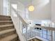 Carpeted stairway with white railings looking down on the kitchen and living room at 1040 Waverly Dr, Longwood, FL 32750