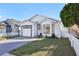 Well-manicured single-story home with a garage and a neat front lawn, framed by a white picket fence at 11136 Einbender Rd, Orlando, FL 32825