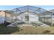 View of screened-in pool area and the back of the house at 11136 Einbender Rd, Orlando, FL 32825