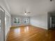 Bright bedroom featuring hardwood floors, white trim, windows with blinds, and a ceiling fan at 112 Woden Way, Winter Haven, FL 33884