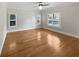 This bright bedroom features three windows with plantation shutters and hardwood floors at 112 Woden Way, Winter Haven, FL 33884