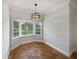 Bright dining area with a bay window offering natural light and decorative light fixture at 112 Woden Way, Winter Haven, FL 33884