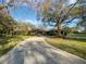 Charming single-story home with a large yard, mature trees, and a long private driveway at 112 Woden Way, Winter Haven, FL 33884