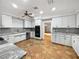 Spacious kitchen with white cabinets, stainless steel appliances, and unique tile flooring at 112 Woden Way, Winter Haven, FL 33884