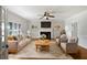 Cozy living room with a fireplace, ceiling fan, and ample seating for a comfortable gathering space at 112 Woden Way, Winter Haven, FL 33884