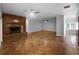 Large living room with a wood-burning fireplace and unique tile and hardwood flooring at 112 Woden Way, Winter Haven, FL 33884