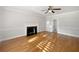 Bright living room features a fireplace, ceiling fan and hardwood floors at 112 Woden Way, Winter Haven, FL 33884