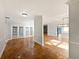 Open concept living space with unique tile and hardwood flooring, bright light, and entryways to kitchen at 112 Woden Way, Winter Haven, FL 33884