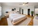 Relaxing main bedroom featuring a king bed, ceiling fan, hardwood floors, and ensuite bathroom and closet at 112 Woden Way, Winter Haven, FL 33884