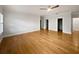 Spacious main bedroom featuring hardwood floors, a ceiling fan, and entryways to closet and bathroom at 112 Woden Way, Winter Haven, FL 33884