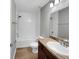 Bathroom featuring modern vanity with marble-look countertop, wood-look floors and a shower and tub at 11392 Sw 58Th Cir, Ocala, FL 34476