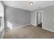 Neutral bedroom with carpeted flooring, window with blinds, and a door to the bathroom at 11392 Sw 58Th Cir, Ocala, FL 34476