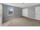 Cozy bedroom with neutral carpet and a large window for natural light at 11392 Sw 58Th Cir, Ocala, FL 34476