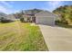 Two-story home featuring an attached two-car garage and a well-manicured lawn at 11392 Sw 58Th Cir, Ocala, FL 34476