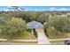 Aerial view of a single-Gathering home with a well-manicured lawn and mature trees at 114 Alexandria Cir, Deland, FL 32724