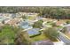 An aerial view of a neighborhood showcasing various homes with lush trees at 114 Alexandria Cir, Deland, FL 32724