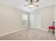 Bright bedroom showcases a ceiling fan, neutral walls, and a double closet at 114 Alexandria Cir, Deland, FL 32724