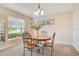 Bright dining area with a window, a chandelier and beach art hanging on the wall at 114 Alexandria Cir, Deland, FL 32724