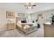 Light-filled main bedroom features a ceiling fan, neutral paint, and plush carpet at 114 Alexandria Cir, Deland, FL 32724